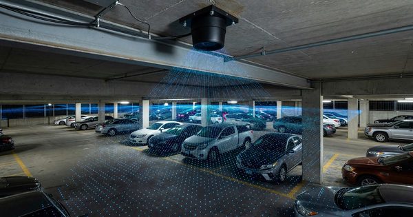 Overhead LiDAR sensor mounted on parking garage ceiling scanning vehicles below with point cloud visualization